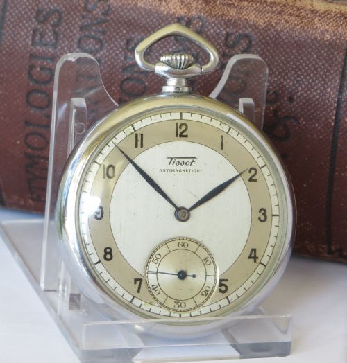 fig 1. An Art Deco open-face Tissot Antimagnetique pocket watch featuring a silver-tone case, cream two-tone dial, Arabic numerals, and a sub-seconds dial.