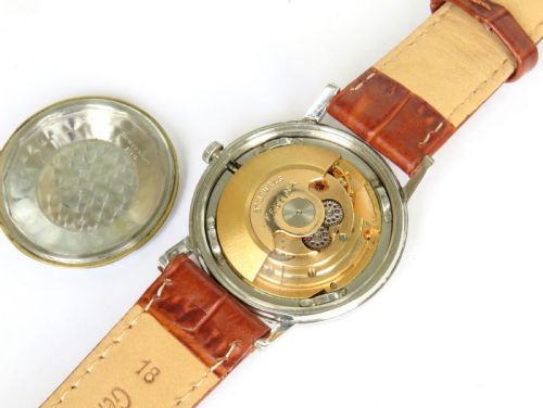 fig 2. A gents 1950s Festina automatic wristwatch featuring a champagne dial, silver-tone case, and brown leather strap.
