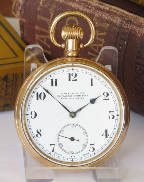 fig 1. An open face stem winding gold pocket watch featuring a white enamel dial with black Arabic numerals and a subsidiary seconds subdial.