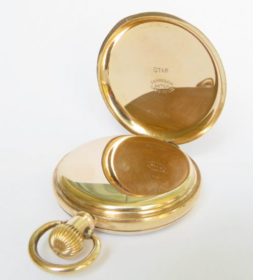 fig 2. An open face stem winding gold pocket watch featuring a white enamel dial with black Arabic numerals and a subsidiary seconds subdial.