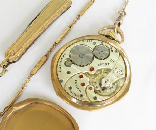 fig 1. An Art Deco gold-filled open-face pocket watch featuring a geometric two-tone dial with Arabic numerals, sub-seconds dial, and an accompanying chain.