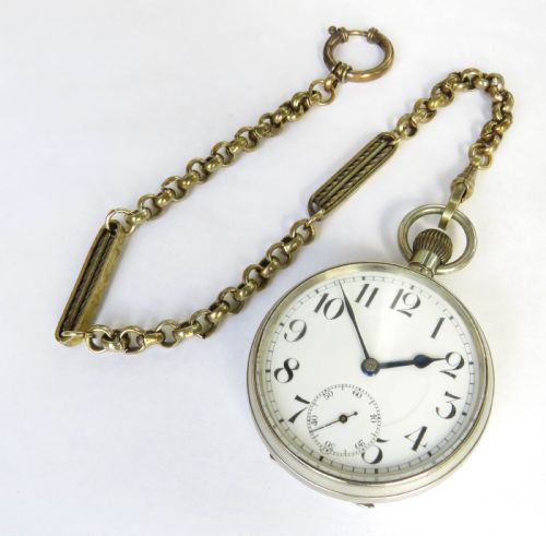 fig 2. An antique silver-tone Octava 8-day open-face pocket watch featuring a white enamel dial with black Arabic numerals and an attached chain.