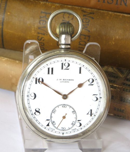 fig 1. A silver open-face pocket watch with a white enamel dial, black Arabic numerals, and a small subsidiary seconds subdial at six oclock.