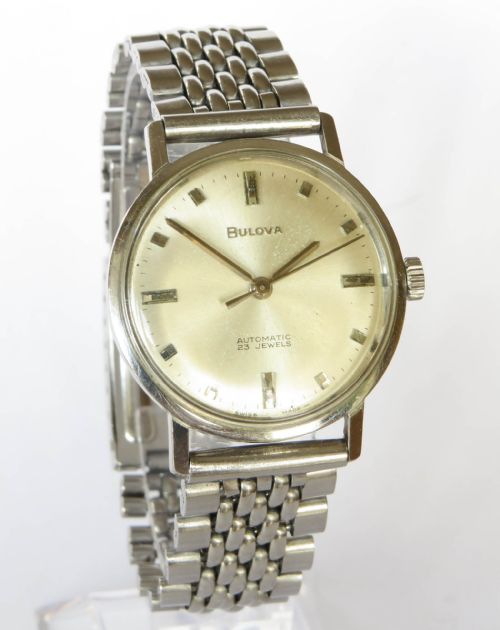 fig 1. A 1967 gents Bulova automatic wristwatch with a champagne dial, stainless steel case, and beads-of-rice metal bracelet.