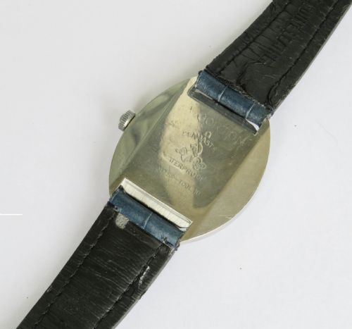 fig 2. A 1960s gents Omega Seamaster Cosmic wristwatch featuring a stainless steel cushion case, silver dial with date display, and a blue leather strap.