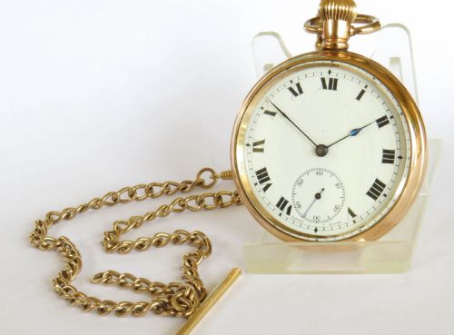 fig 1. An antique gold-toned open-face pocket watch featuring a white enamel dial with black Roman numerals, blued steel hands, a subsidiary seconds dial, and an attached gold-toned Albert chain.