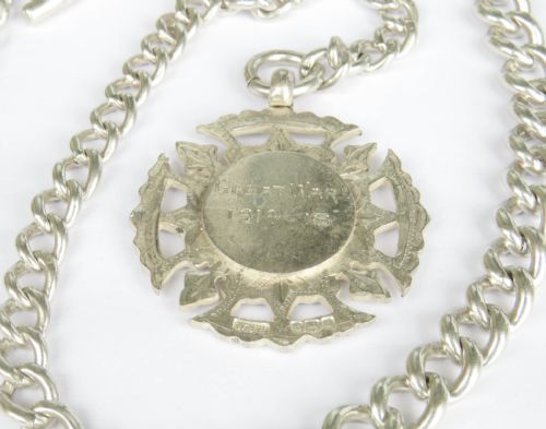 fig 1. A sterling silver curb link Albert pocket watch chain featuring a T-bar, swivel clasp, and a carved Great War 1914-1918 medallion fob.