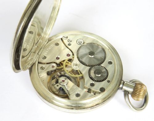 fig 3. An open-face antique silver pocket watch featuring a white enamel dial with black Roman numerals and a subsidiary seconds sub-dial.