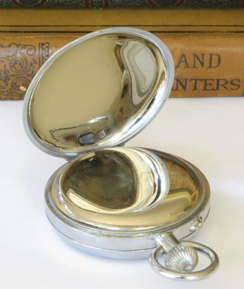 fig 2. A 1930s open-face chronograph pocket watch featuring a white dial with Roman numerals, two subsidiary dials, and a chrome-plated metal case.