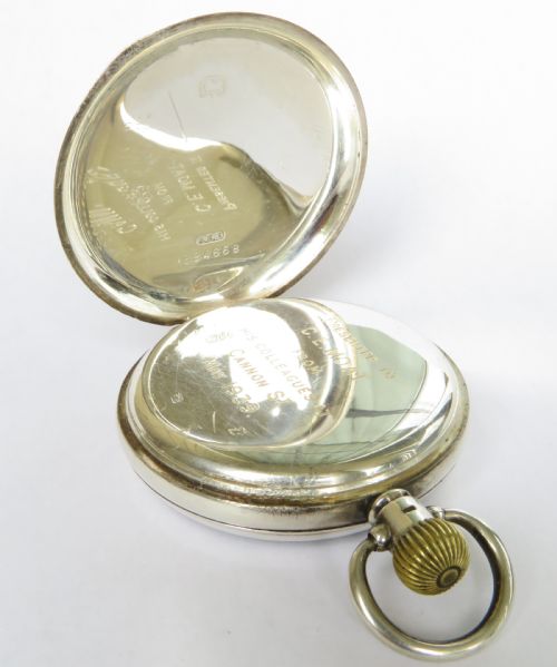 fig 2. A 1930s open-face pocket watch featuring a silver case, white enamel dial with black Arabic numerals, and a subsidiary seconds dial at six oclock.