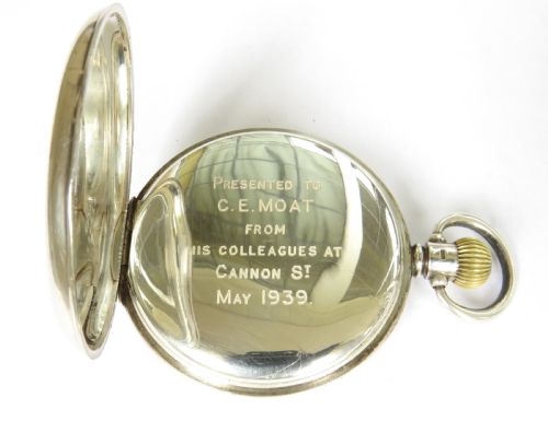 fig 3. A 1930s open-face pocket watch featuring a silver case, white enamel dial with black Arabic numerals, and a subsidiary seconds dial at six oclock.