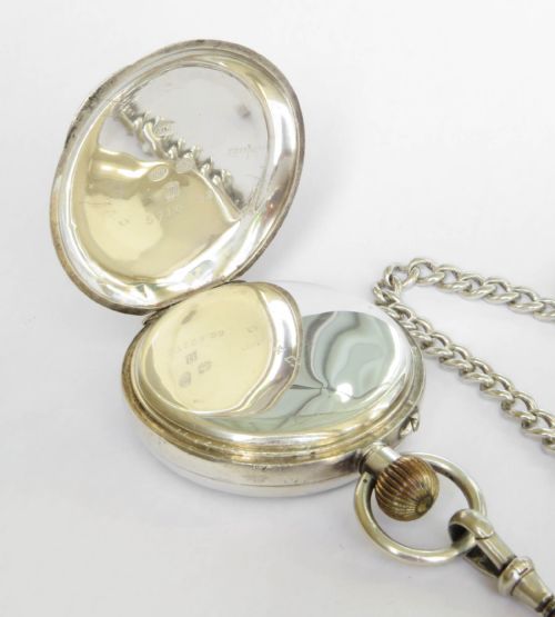 fig 2. An antique Edwardian open-face silver pocket watch with a white enamel Roman numeral dial and an attached silver T-bar chain.