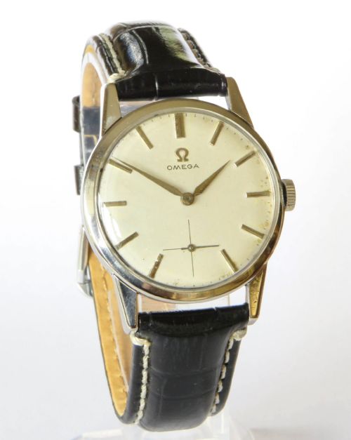fig 1. A 1960s gents Omega wristwatch with a round stainless steel case, a cream dial featuring baton markers and a sub-seconds dial, paired with a stitched black leather strap.