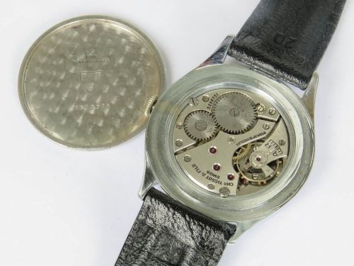 fig 2. A 1950s Tissot gents wristwatch featuring a cream dial with black Arabic numerals, a sub-seconds subdial at six oclock, a steel case, and a black leather strap.
