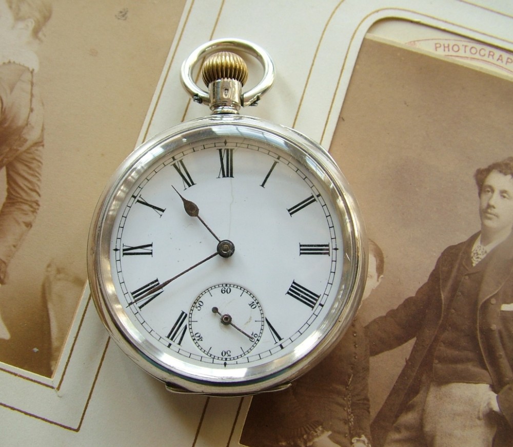 An antique silver Omega pocket watch