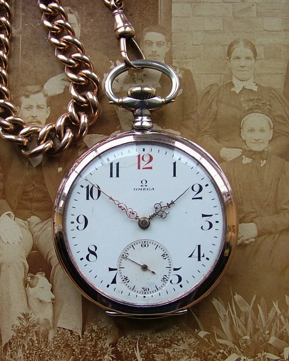An antique Omega pocket watch and double albert