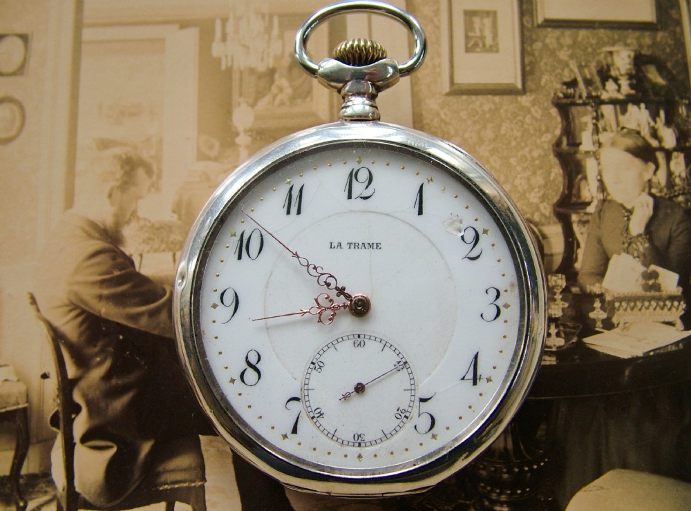 A silver La Trame pocket watch