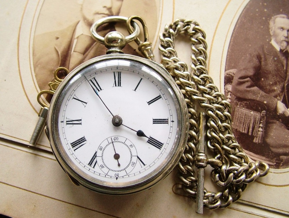 An antique key-winding pocket watch with chain