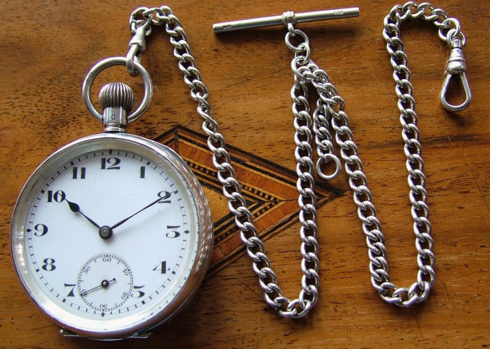 An antique Swiss silver pocket watch and chain