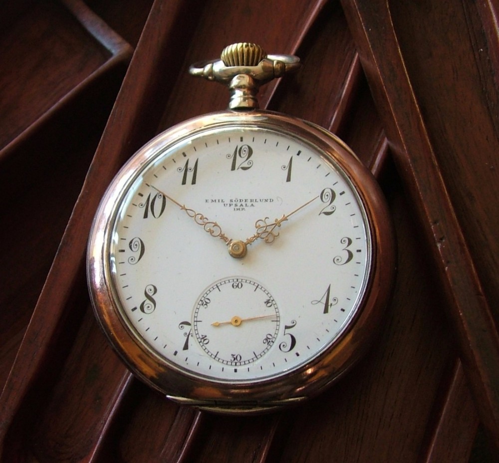 An antique silver Omega pocket watch