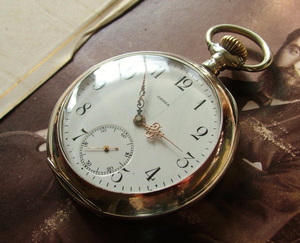 An antique silver Omega pocket watch