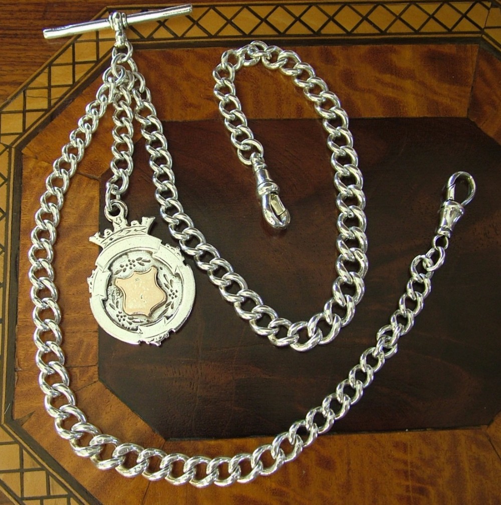 An antique silver double pocket watch chain & fob