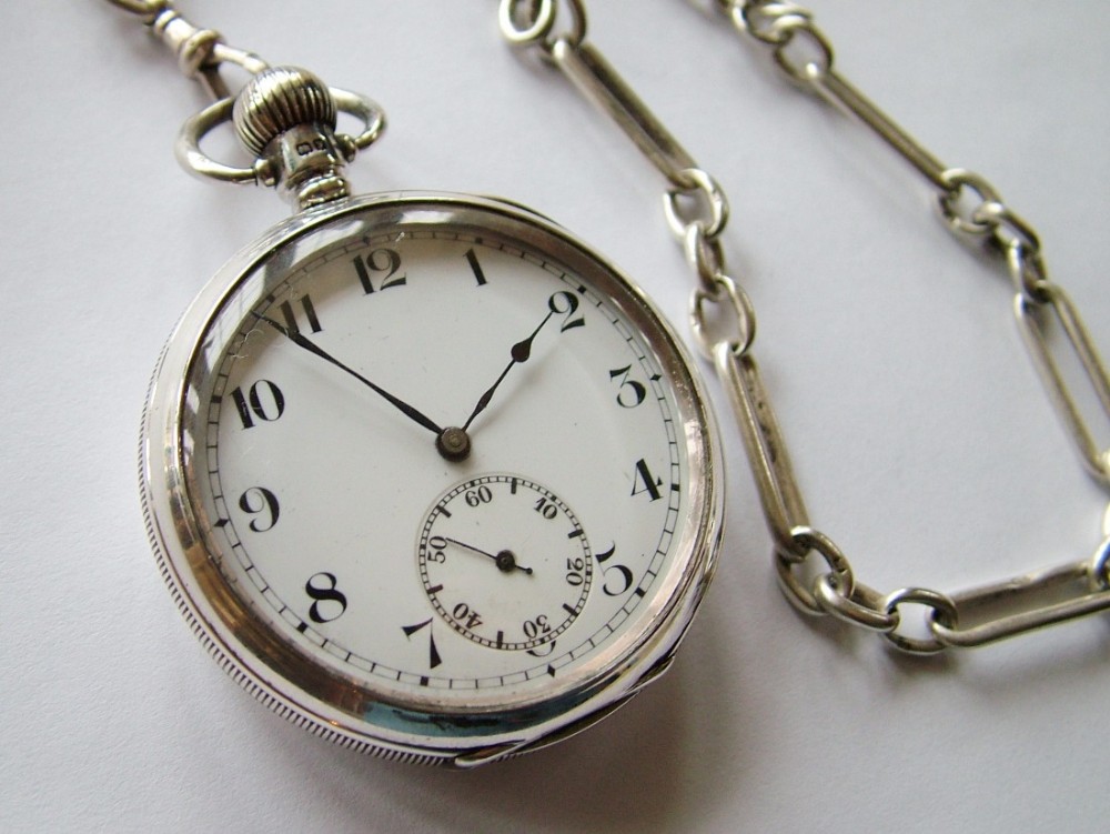 A Swiss open faced silver pocket watch with chain