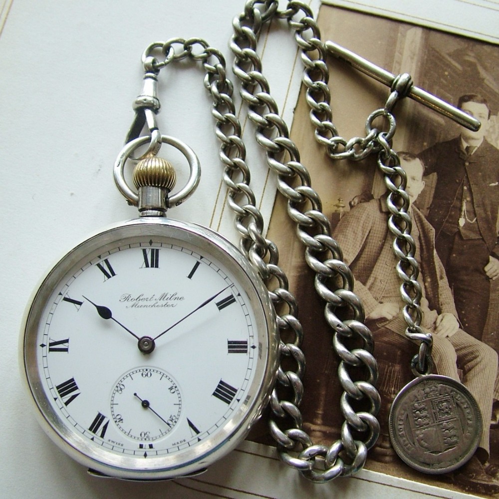 An antique silver pocket watch with silver chain