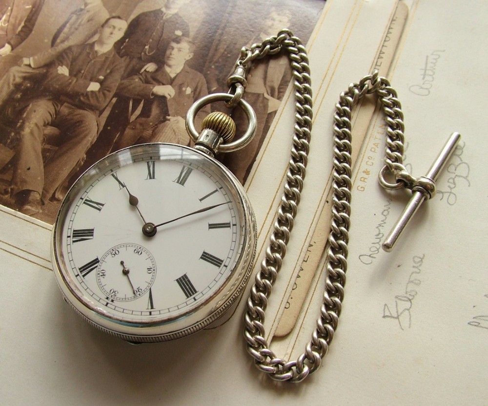 Antique silver open faced pocket watch and chain