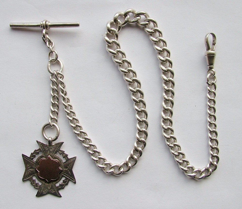 An antique silver single pocket watch chain and fob.