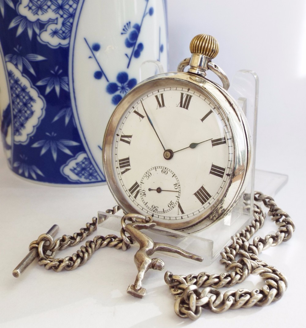 An antique silver Record pocket watch with chain