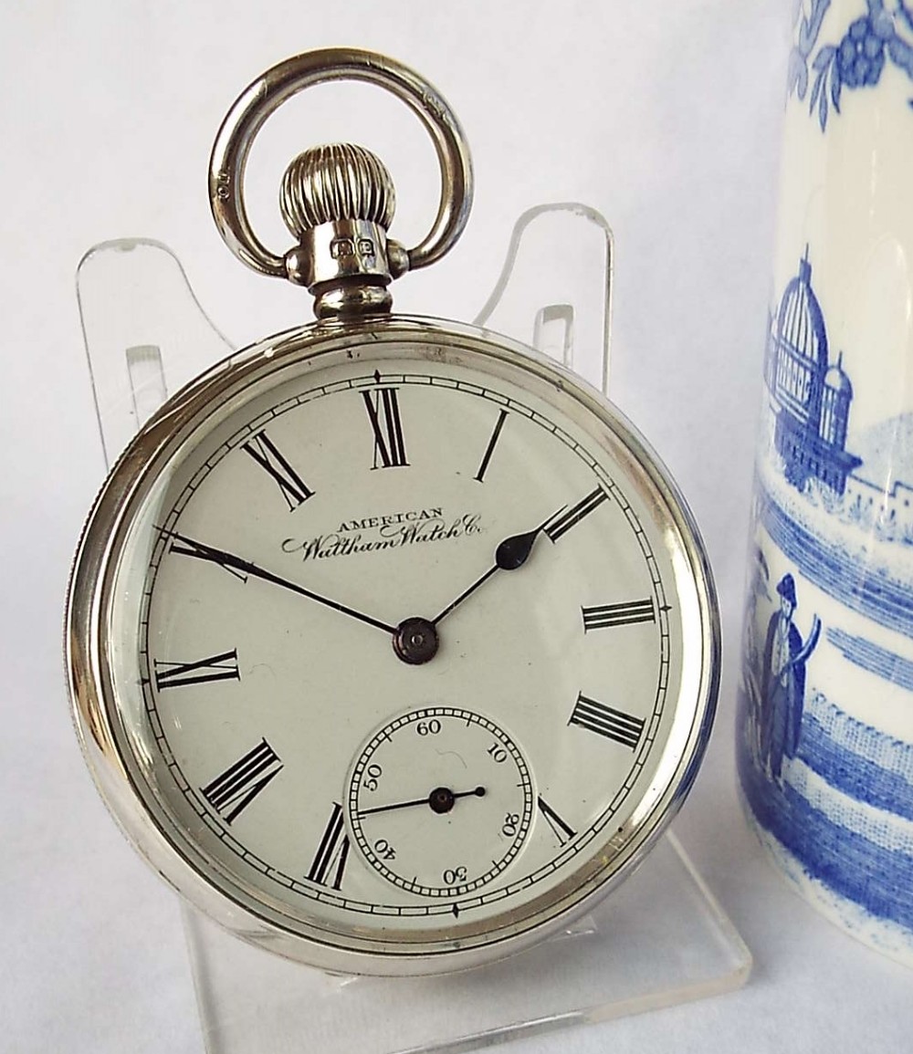 An antique silver Waltham Traveler pocket watch.