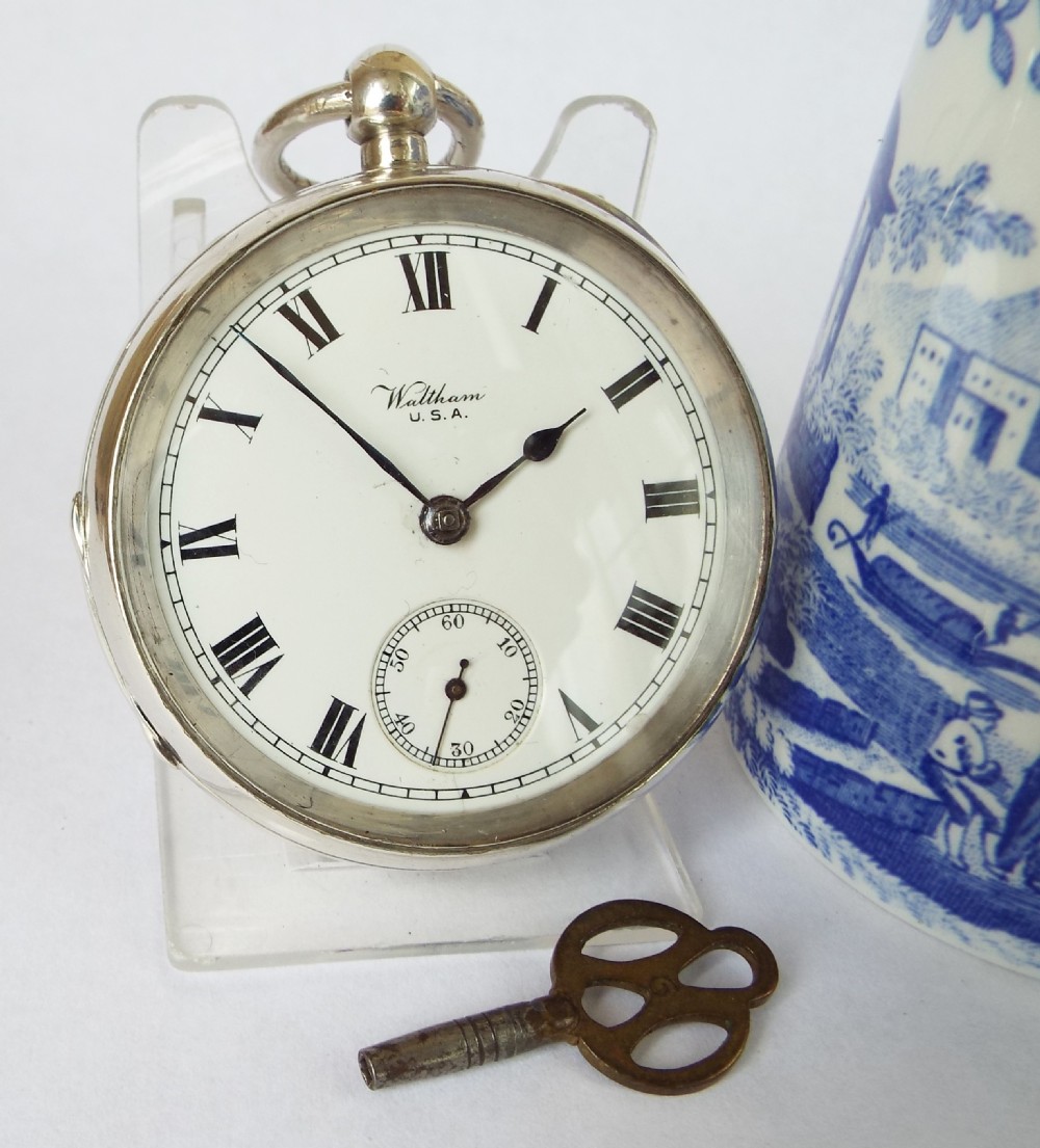 An antique silver Waltham pocket watch.