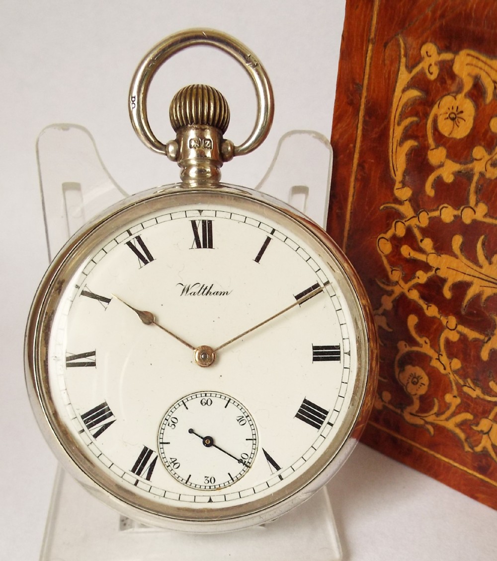 An antique silver Waltham pocket watch.