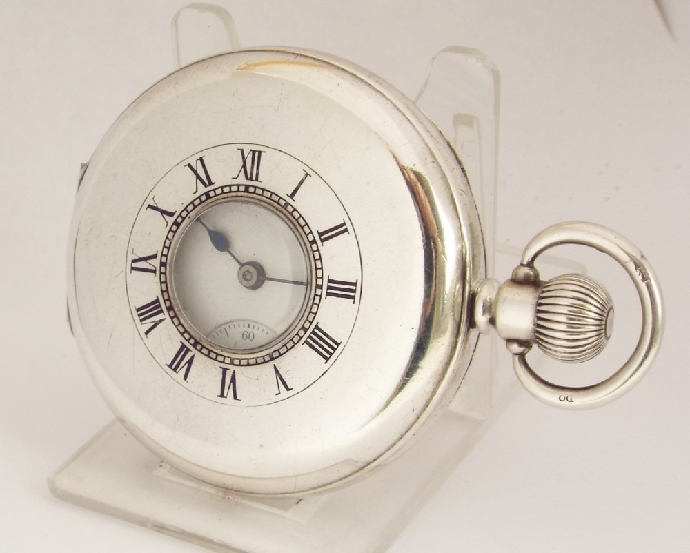 A 1920s silver half hunter Waltham pocket watch.