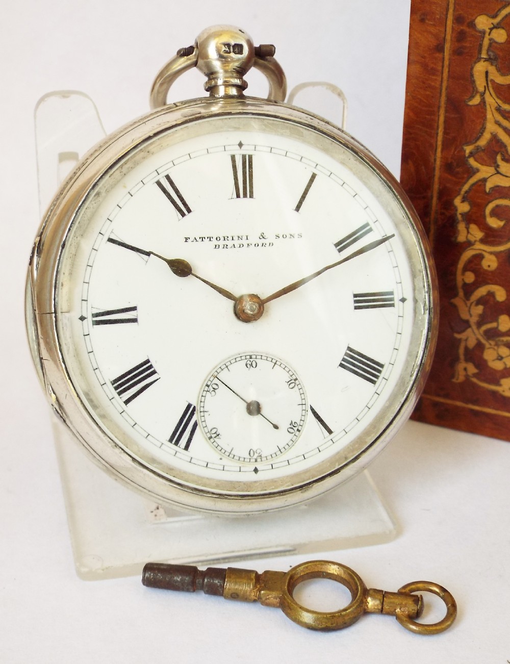 An antique silver Waltham pocket watch.
