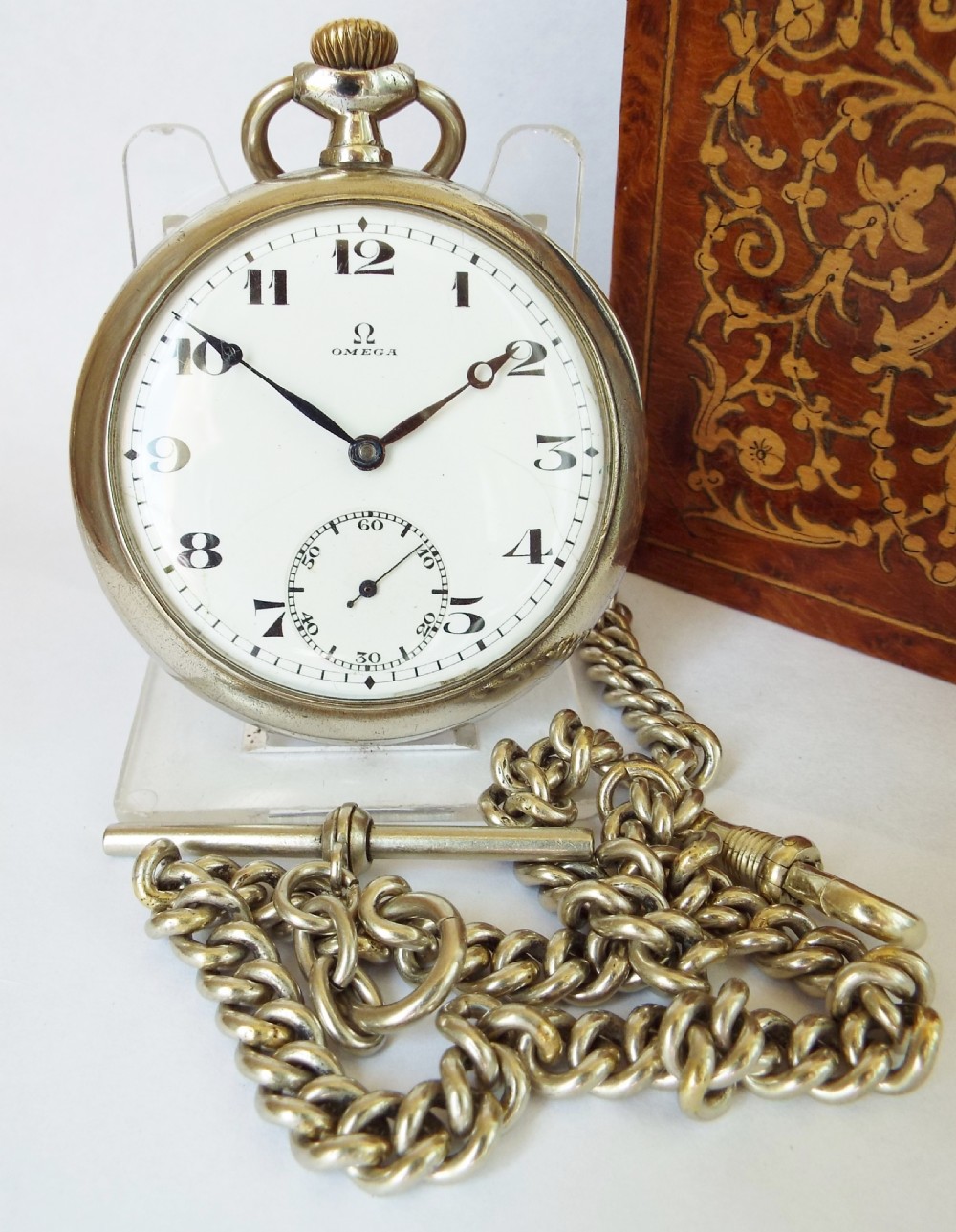 An antique 1917 Omega pocket watch and chain .