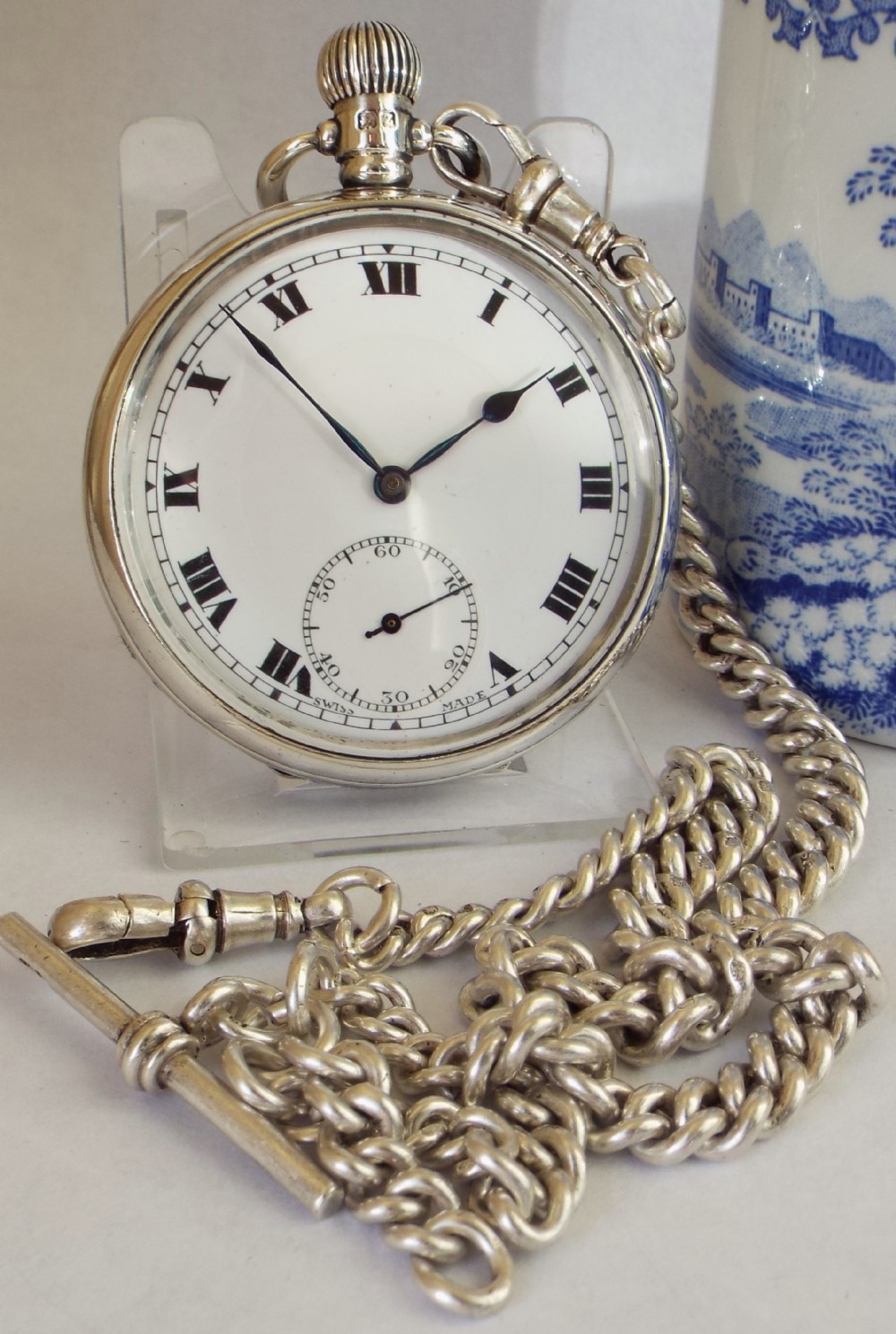 A 1920s silver pocket watch and chain.