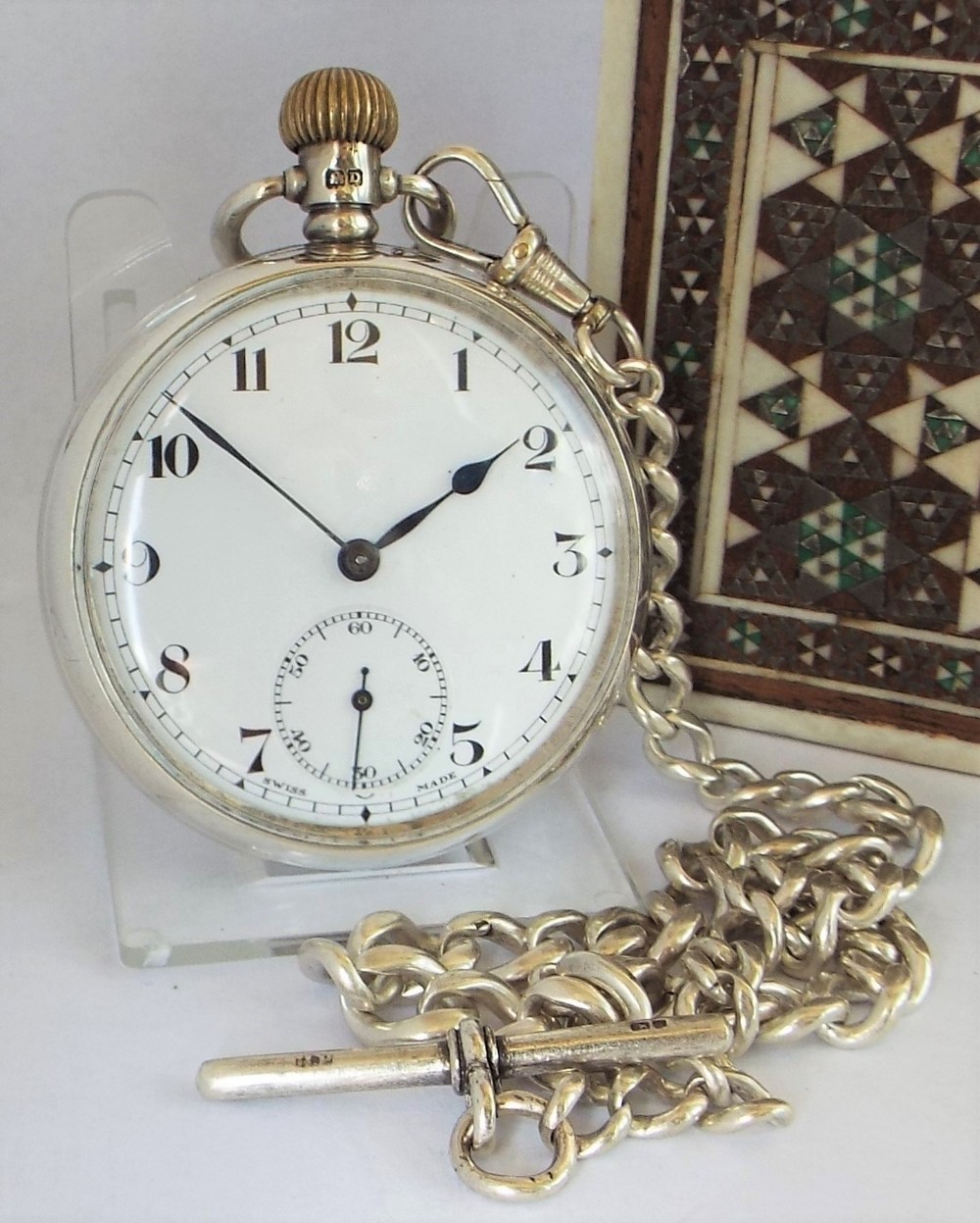 A 1920s silver Cyma pocket watch with chain.