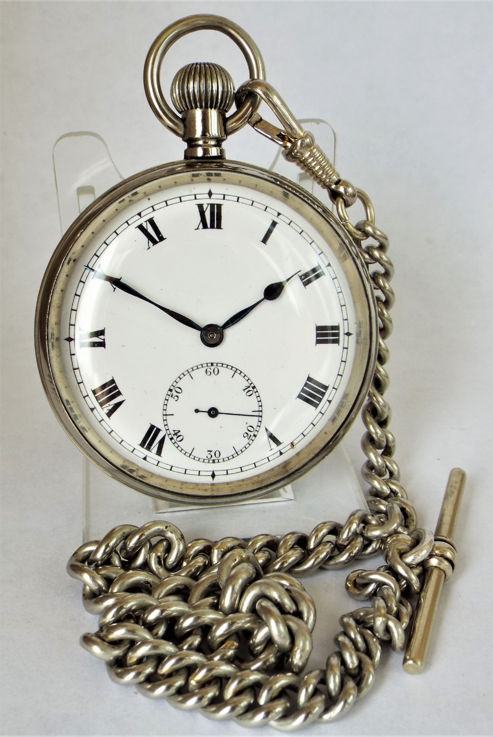 A 1920s Cyma pocket watch with chain.