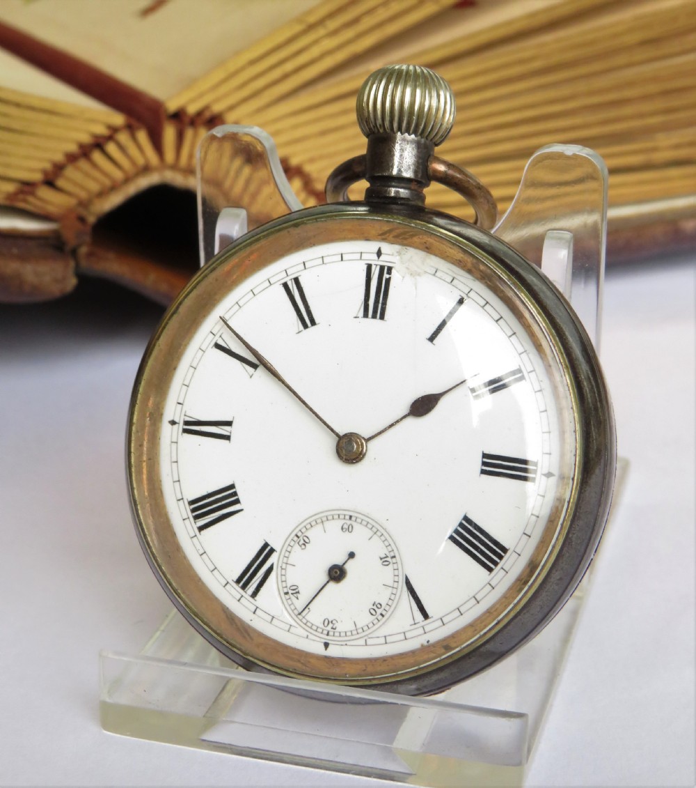 An antique gun metal Omega pocket watch.