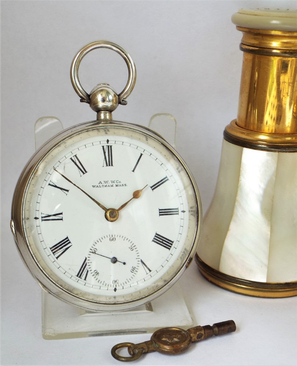 An antique silver Waltham pocket watch.