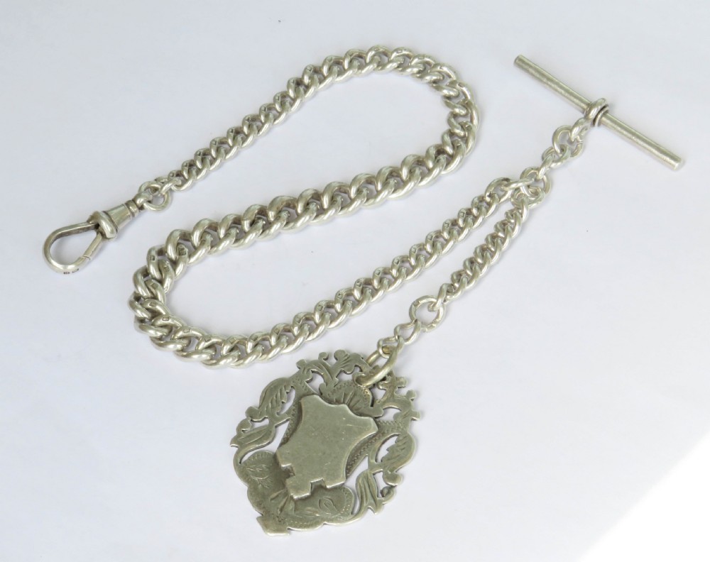 Antique silver watch chain and Tug Of War fob