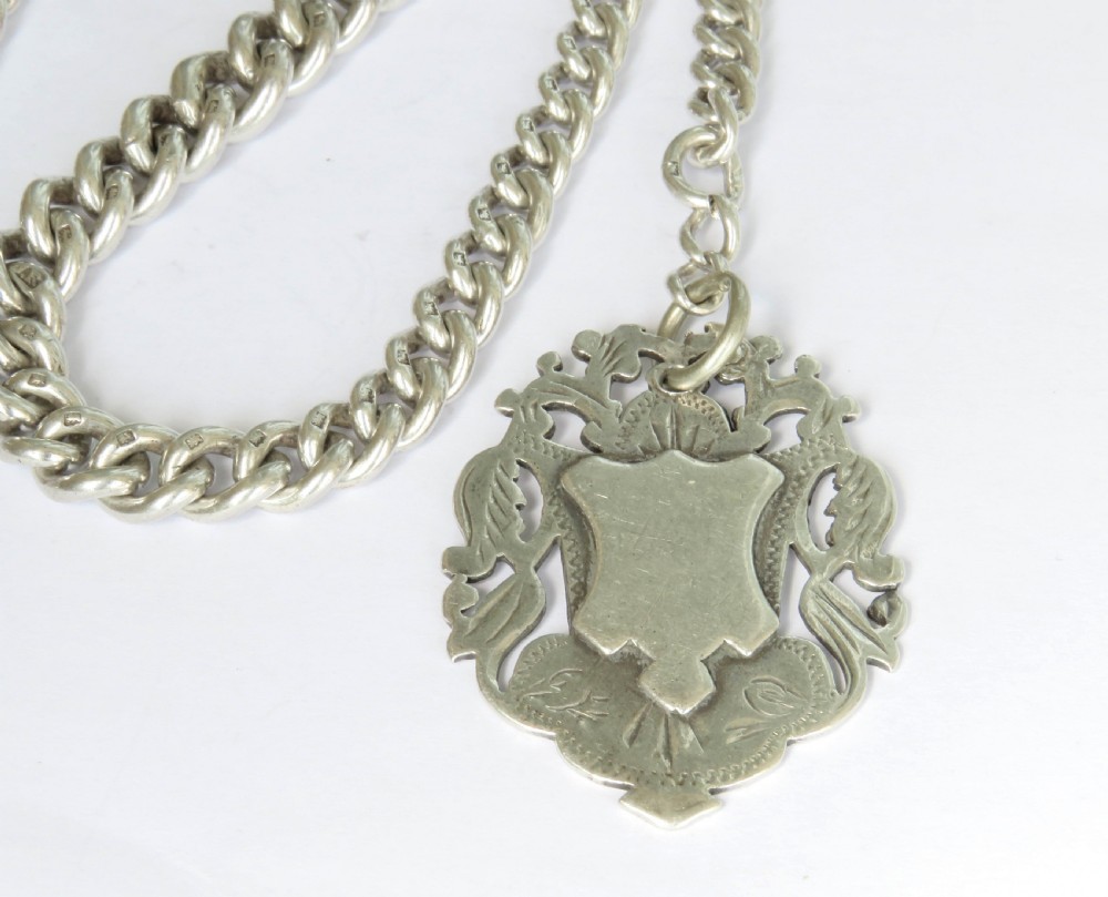 Antique silver watch chain and Tug Of War fob View II