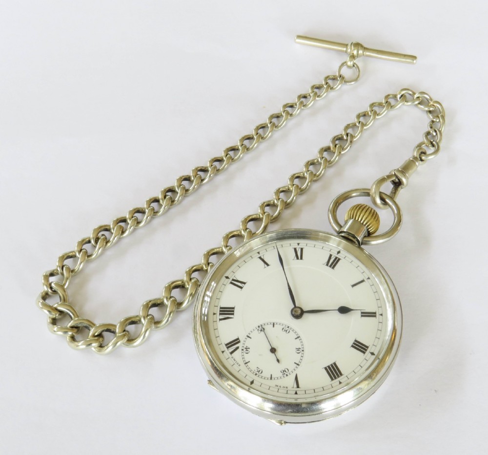 An open-face 1930s Doxa pocket watch with a white enamel dial, black Roman numerals, sub-seconds dial, and attached silver-toned Albert chain. View II