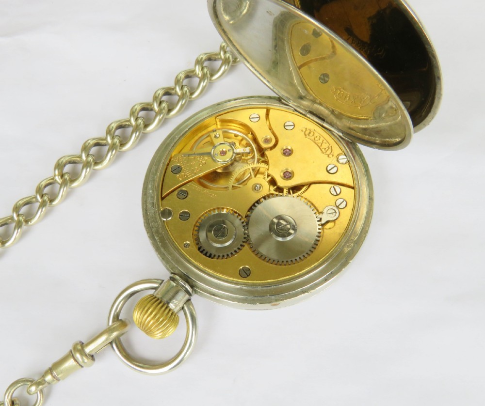 An open-face 1930s Doxa pocket watch with a white enamel dial, black Roman numerals, sub-seconds dial, and attached silver-toned Albert chain. View III