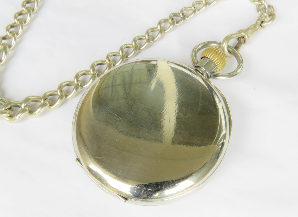 An open-face 1930s Doxa pocket watch with a white enamel dial, black Roman numerals, sub-seconds dial, and attached silver-toned Albert chain. View V