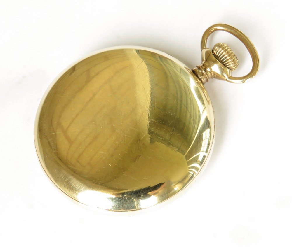 An open-face gold-tone pocket watch featuring a white enamel dial with black Arabic numerals, sub-seconds dial, and attached T-bar chain. View VI