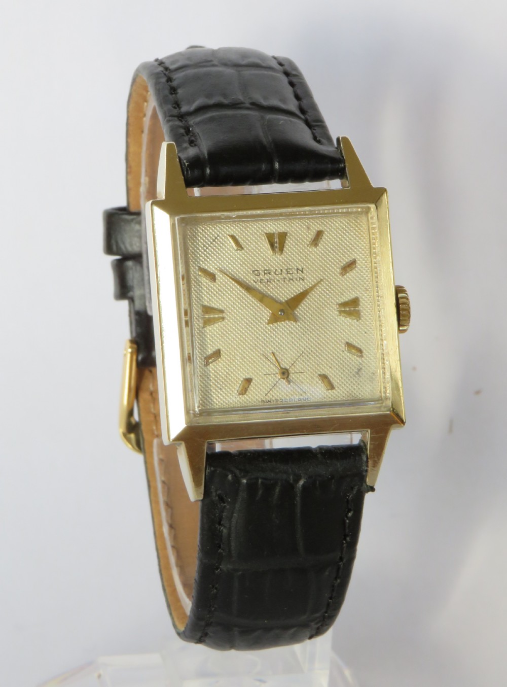 A gents vintage 1950s square gold-cased Gruen Veri-Thin wristwatch with a textured dial and a black alligator-grain leather strap. View II