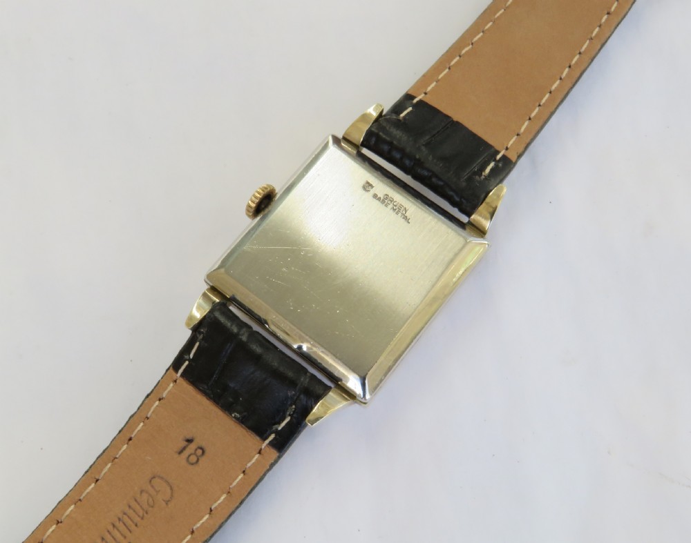 A gents vintage 1950s square gold-cased Gruen Veri-Thin wristwatch with a textured dial and a black alligator-grain leather strap. View V